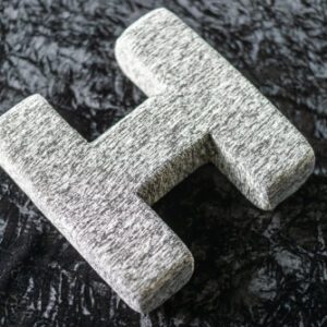 A granite letter h on the ground