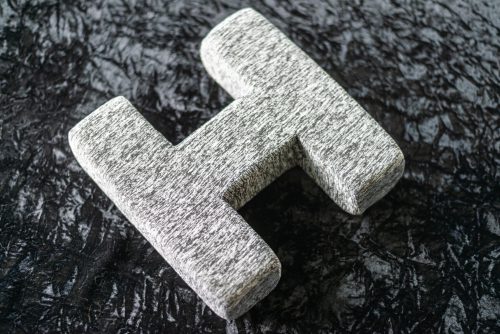 A granite letter h on the ground