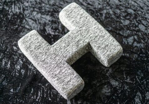 A granite letter h on the ground